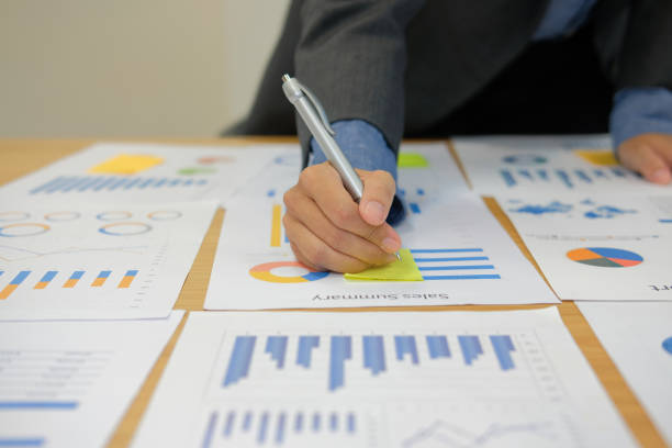 istock Businessman writing on sticky note on business document. paper reminder schedule for creativity idea 1057213840