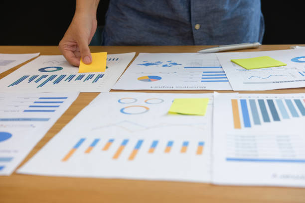 istock Businessman holding sticky note on business document. paper reminder schedule for creativity idea 1057213932