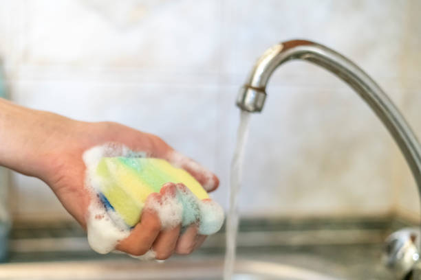 istock cropped image of hand using foam sponge domestic cleaner  f 1057218548