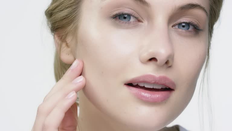 Portrait of smiling woman applying face cream