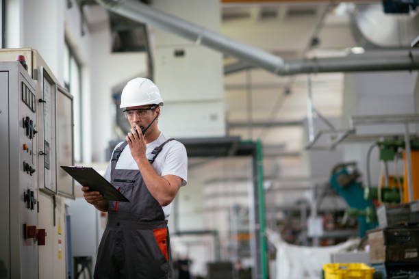 istock Factory worker talking on walkie talkie 1057219216