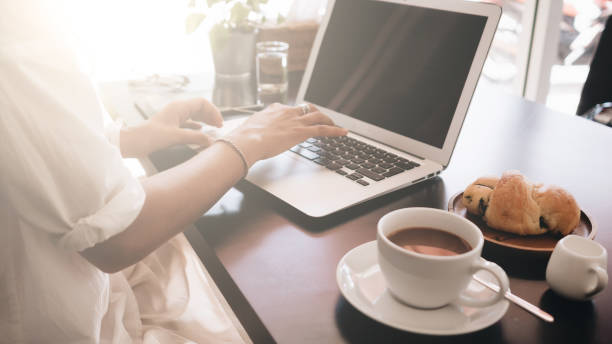 istock Woman working on her laptop computer sitting in cafe 1057223712