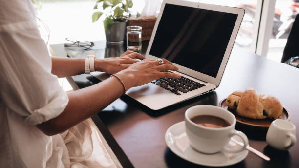 istock Woman working on her laptop computer sitting in cafe 1057224002