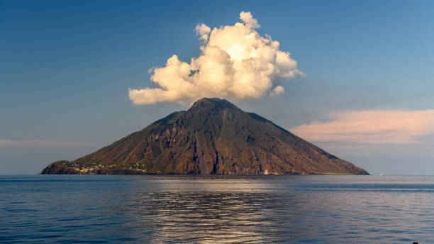 Stromboli Island in the Mediterranean sea view of a smoking Stromboli volcano at sunset volcanic terrain stock pictures, royalty-free photos & images