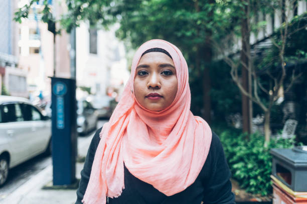 Woman with hijab walking on street