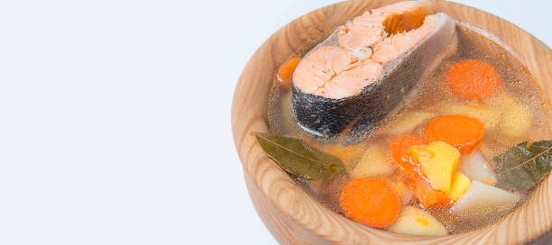 Fish soup with salmon on a white background.