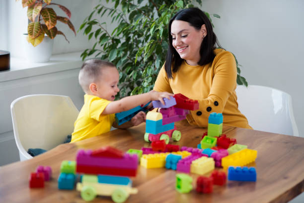 istock Mother and son having fun at home, playing with cubes 1057230724