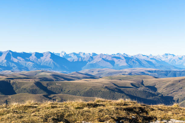 travel to North Caucasus region region - view of Caucasus mountain range from Bermamyt Plateau at autumn morning