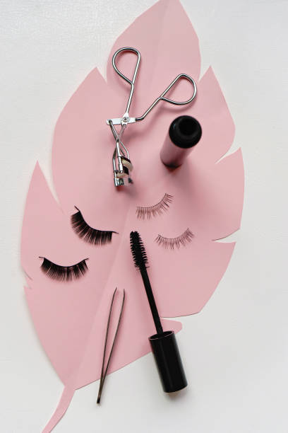 istock Black false lashes strip , mascara, tweezers ,curler  on white background 1057235318