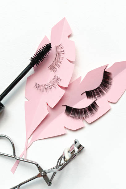 istock Black false lashes strips, mascara, curler  on white background 1057235378