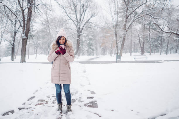 istock woman using phone in the snow 1057237126