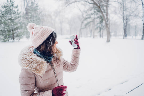 istock woman taking selfies in the snow 1057237802