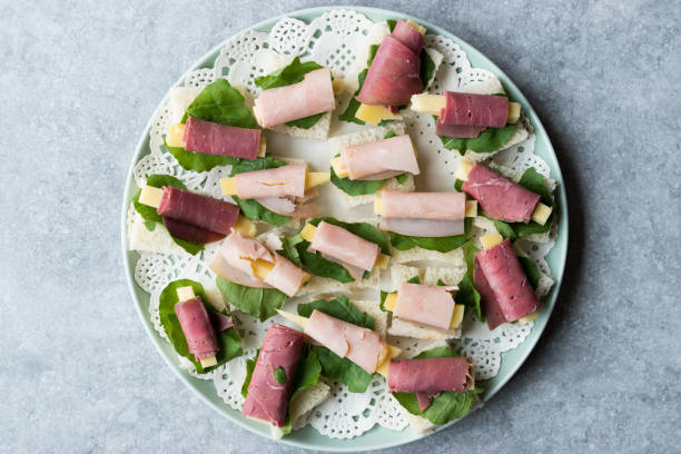 istock Canape Ham Wrapped with Cheese and Greens in Round Plate. 1057238484