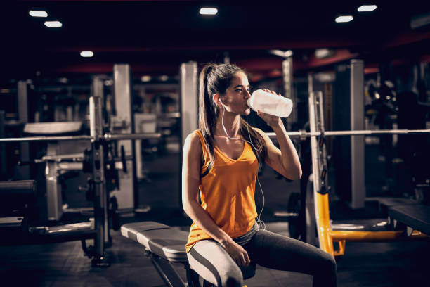 Woman drinking preworkout ripl fitness
