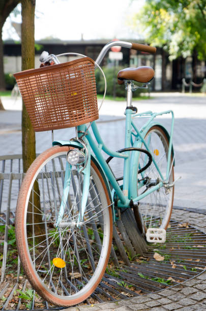 Pale blue bicycle standing on a pole during summer day