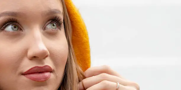 The girl dreamily looks at the sky. Woman in a yellow scarf.