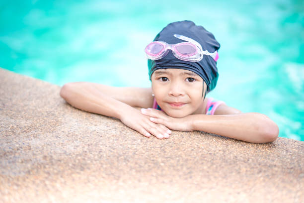 istock Kids swimming in swimming pool on summer 1057253136