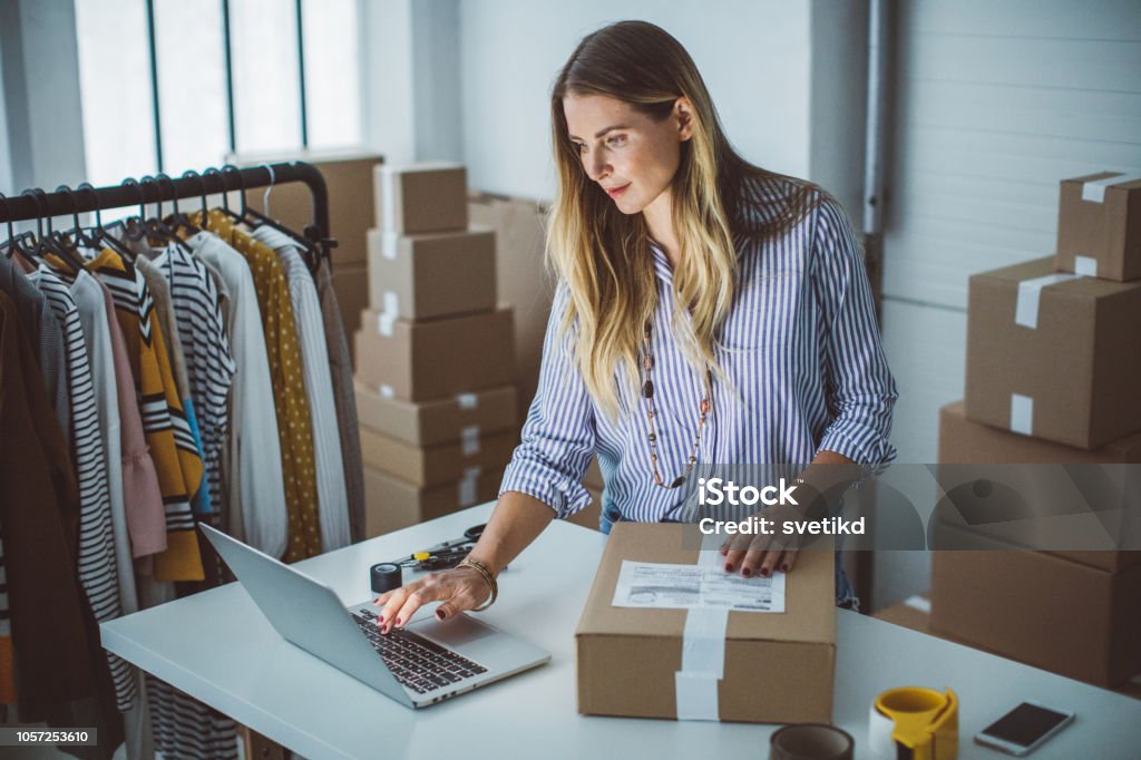 Small business owener Women, owener of small business packing product in boxes, preparing it for delivery. E-commerce Stock Photo