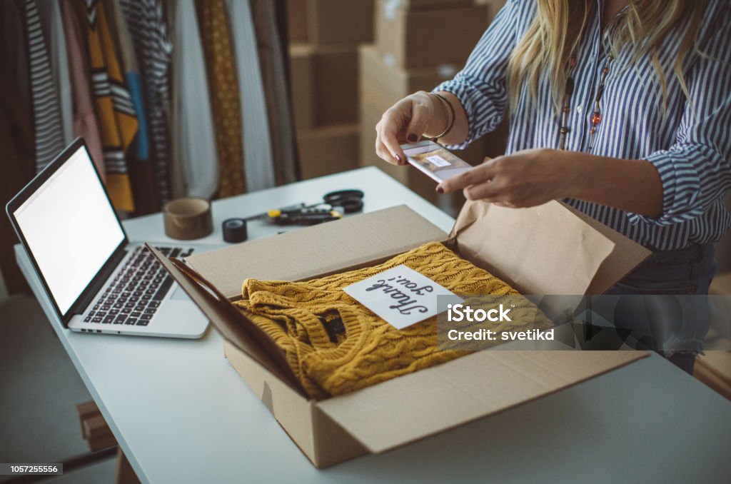Small business owener Women, owener of small business packing product in boxes, preparing it for delivery. E-commerce Stock Photo