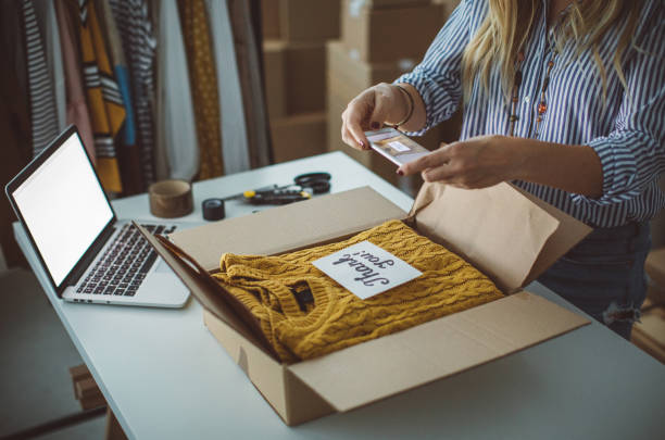 Small business owener Women, owener of small business packing product in boxes, preparing it for delivery. selling photos stock pictures, royalty-free photos & images