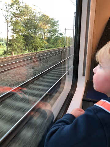 boy's reflection in train window