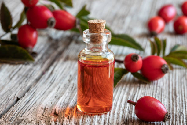 istock A bottle of rose hip seed oil with rose hips 1057259042