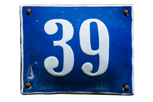 Weathered grunge square metal enameled plate of number of street address with number 39 closeup isolated on white background