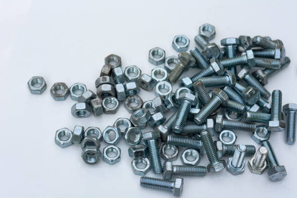 Chrome bolts and nuts closeup on a white background.
