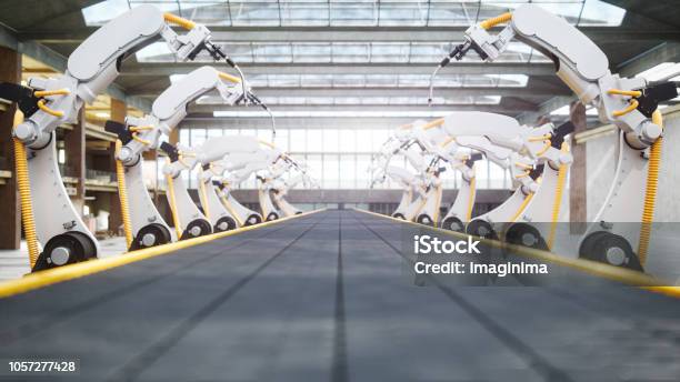 Welding Robots And Conveyor Belt In Automated Factory Stock Photo - Download Image Now