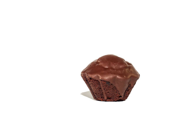 istock Single chocolate black cupcake coated in chocolate isolated on white background 1057280388