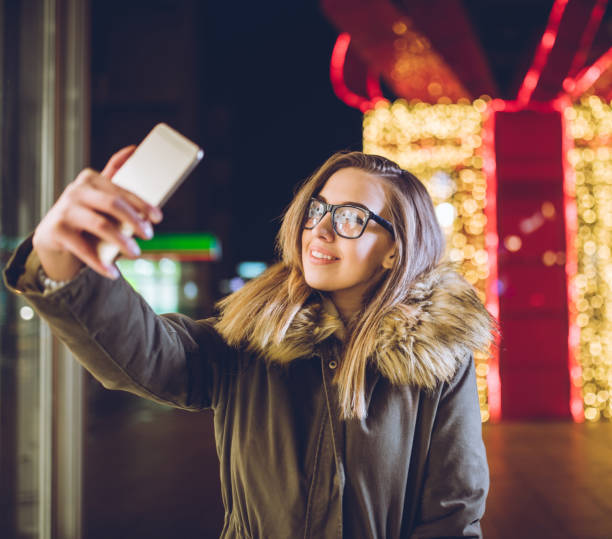istock Woman making selfies downtown at night 1057282772