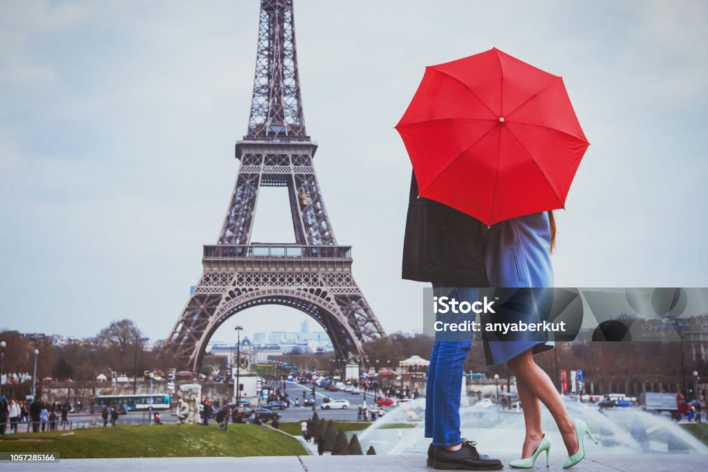 Rmantic couple in Paris kissing near Eiffel towe. romantic holidays for couple in Paris, honeymoon vacation in France, Europe, man and woman kissing near Eiffel tower Romance Stock Photo