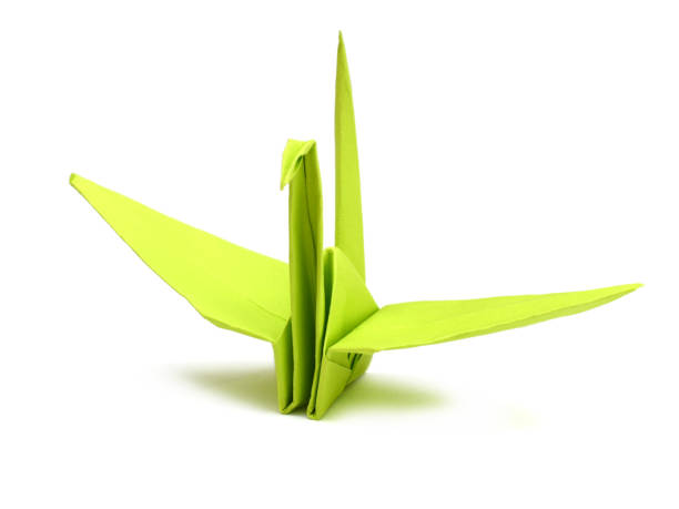 istock A green paper folded Origami crane isolated on white 1057288748