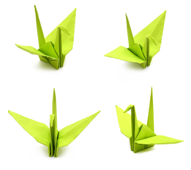 istock A green paper folded Origami crane isolated on white 1057288942