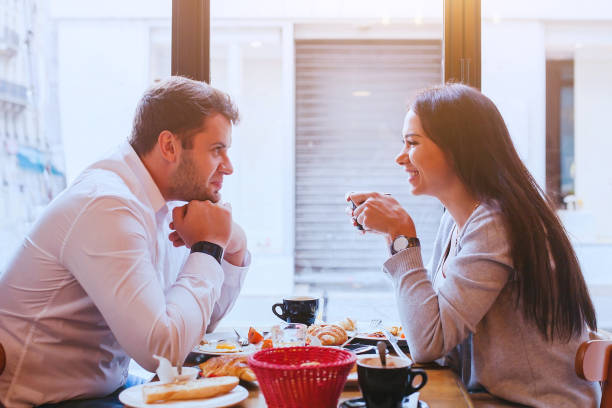 istock couple eating in restaurant and smiling 1057292040