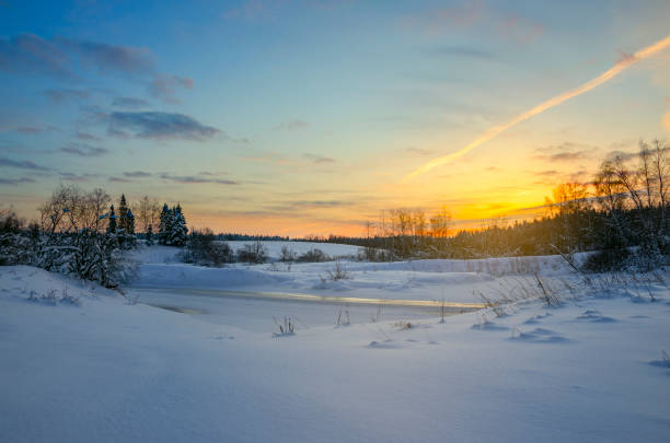 istock Frosty winter landscape with frozen ice bound river. 1057292684