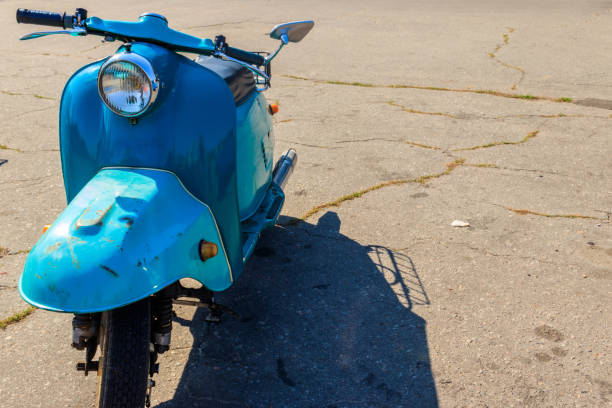 istock Blue retro scooter parked on city street 1057293396