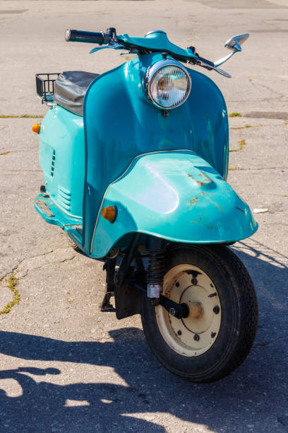 istock Blue retro scooter parked on city street 1057293398