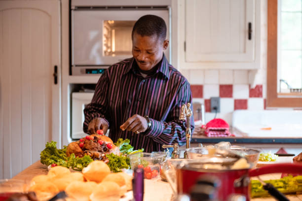 istock Thanksgiving dinner with American-African family preparing dinner 1057301706