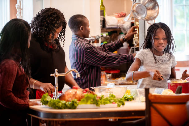 istock Thanksgiving dinner with American-African family preparing dinner 1057301902