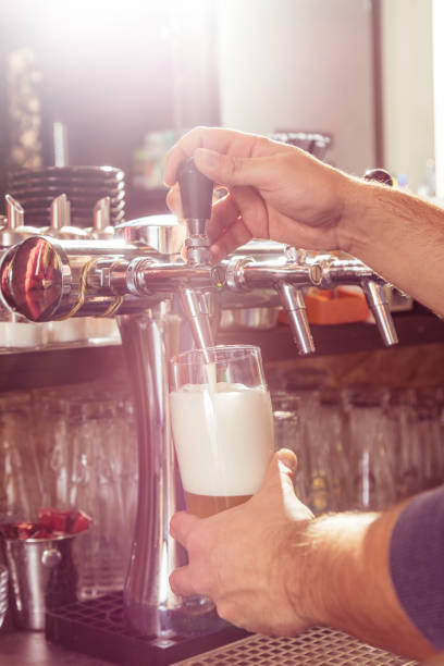 istock Bartender pouring fresh beer from beer tap. 1057302548