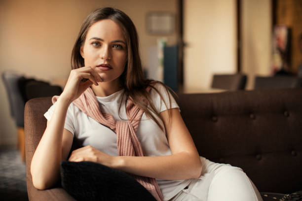 istock young woman sitting in hotel lobby 1057317192