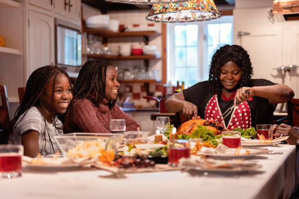 istock American-African family at table during thanksgiving dinner 1057317448