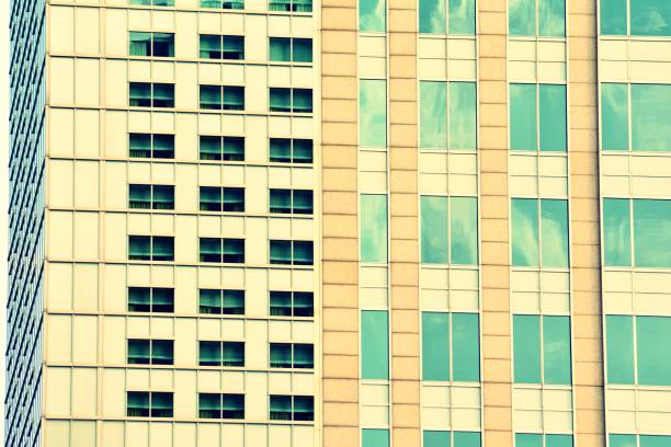 istock Modern office building on a clear sky background. Retro stylized colorful tonal filter effect 1057320664