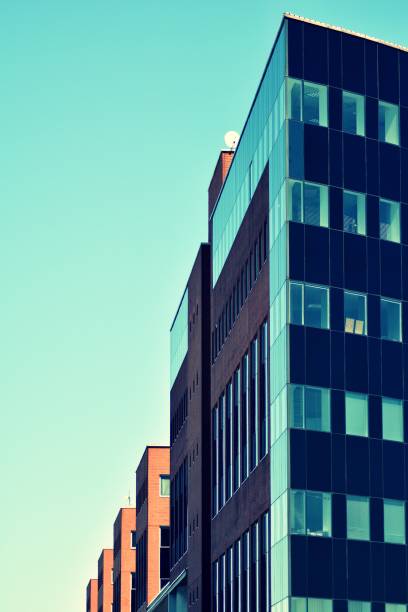 istock Modern office building on a clear sky background. Retro stylized colorful tonal filter effect 1057323468