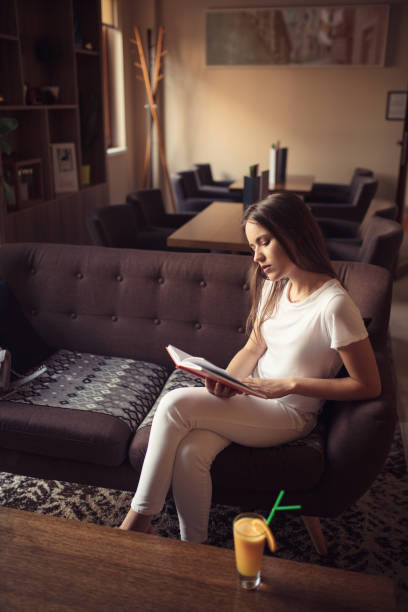 istock young woman sitting in hotel lobby 1057323488