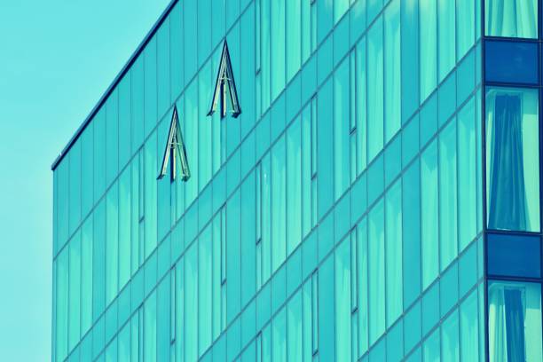 istock Modern office building on a clear sky background. Retro stylized colorful tonal filter effect 1057323564