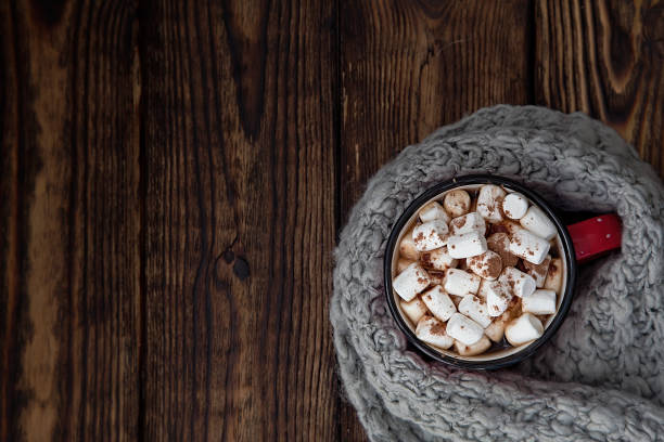 istock red Cup with marshmallow on wooden new year background 1057325128
