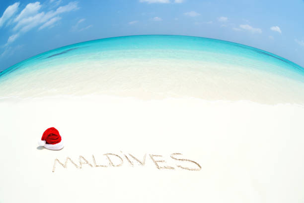 istock Santa Claus hat on perfect tropical bounty beach 1057328350
