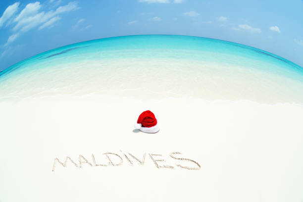 istock Santa Claus hat on perfect tropical bounty beach 1057328370